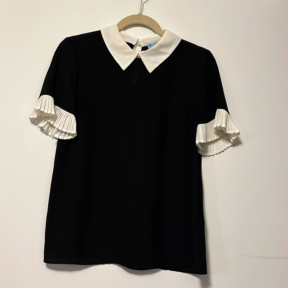 Black blouse with white ruffle detail